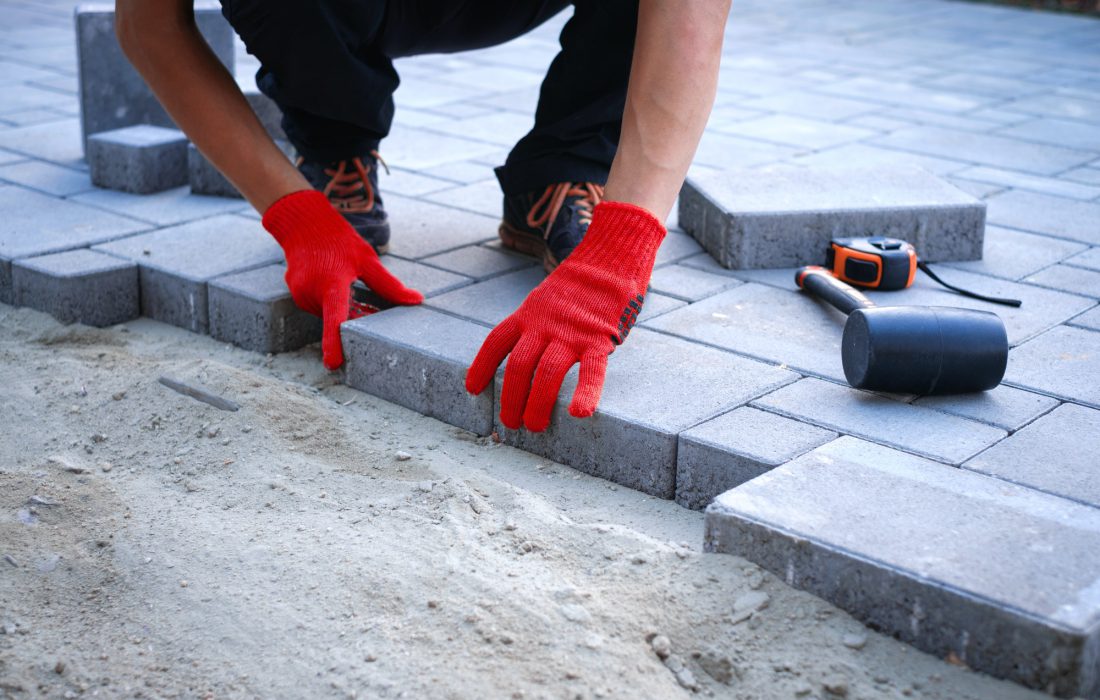 the-master-in-yellow-gloves-lays-paving-stones.jpg